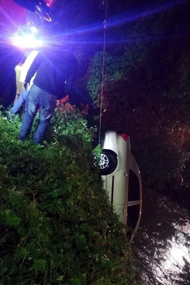 Rescatistas engancharan el coche y lo extrajeron con una grúa para liberar el cadáver.