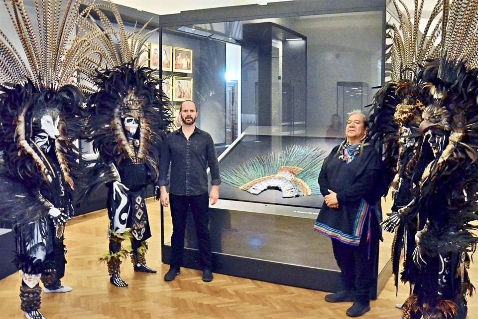El músico Alyosha Barreiro e integrantes del grupo de danza Nok Niuk frente al Penacho de Moctezuma, durante la apertura del Weltmuseum.