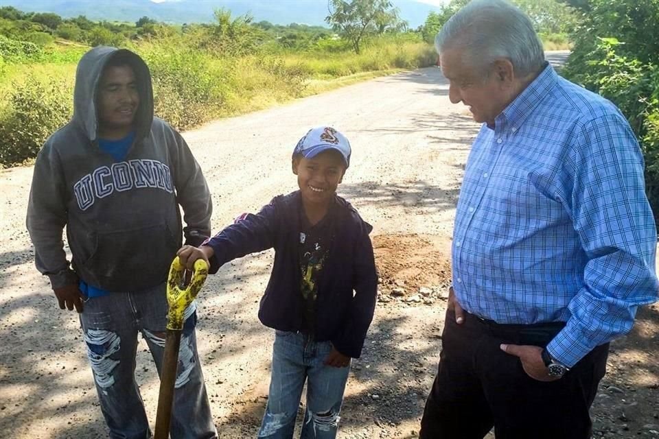 El Axochiapan, el Presidente se encontró a un padre de familia y su hijo que tapaban los baches de la carretera a cambio de pedir monedas.