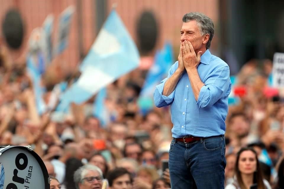 El Presidente Mauricio Macri saluda a las miles de personas que se reúnen en la Plaza de Mayo para despedirlo del cargo como Presidente este sábado, en Buenos Aires.