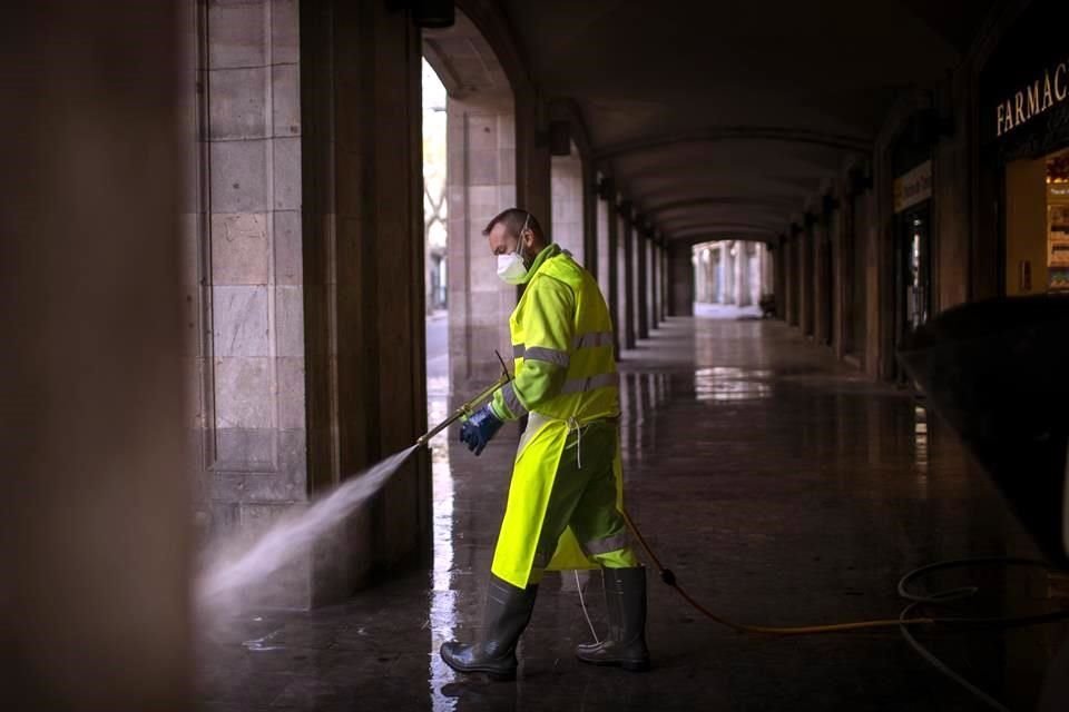 Un trabajador desinfecta en la ciudad de Barcelona, para evitar el contagio de coronavirus.