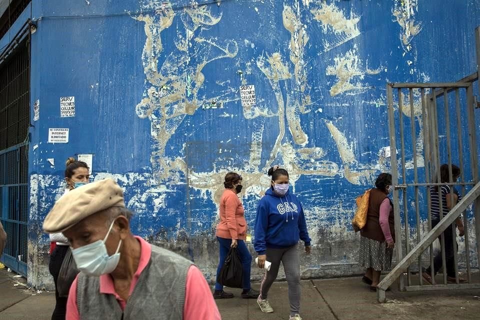 En un mercado de Lima, Perú, la gente usa cubrebocas para prevenir la propagación del virus.