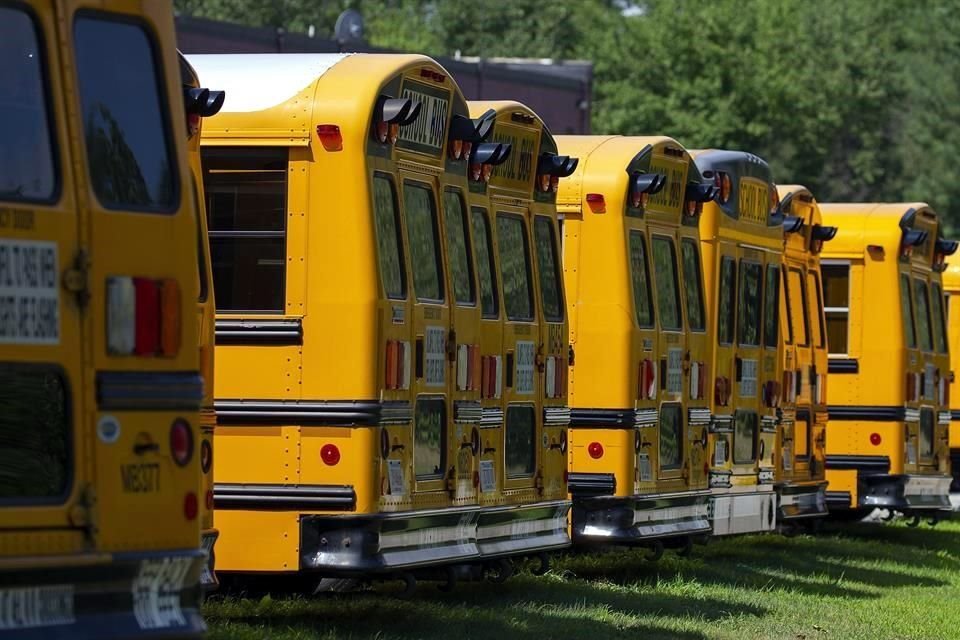 Camiones escolares en Massachusets permanecen parados ante la suspensión de clases por la pandemia de Covid-19.