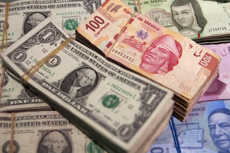 A stack of Mexican hundred peso bills and U.S. dollar bills are arranged for a photograph inside a currency exchange in Mexico City, Mexico, on Tuesday April 9, 2013.