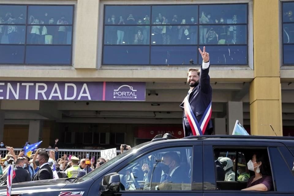 Boric hace el signo de la victoria mientras recorre las calles.