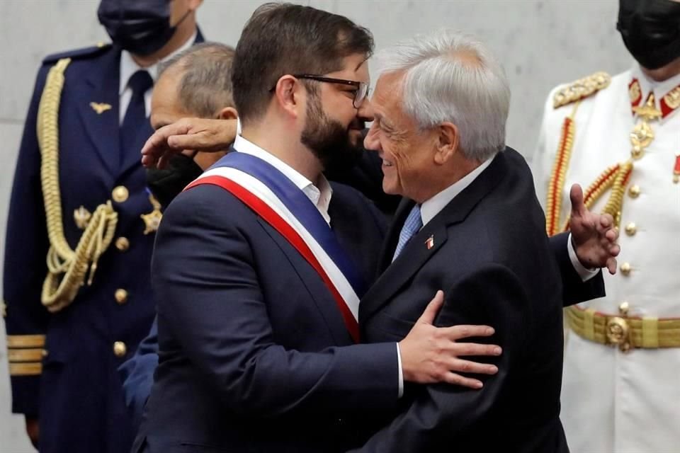 El Mandatario saliente, Sebastián Piñera, de derecha, abraza a su sucesor, de izquierda.