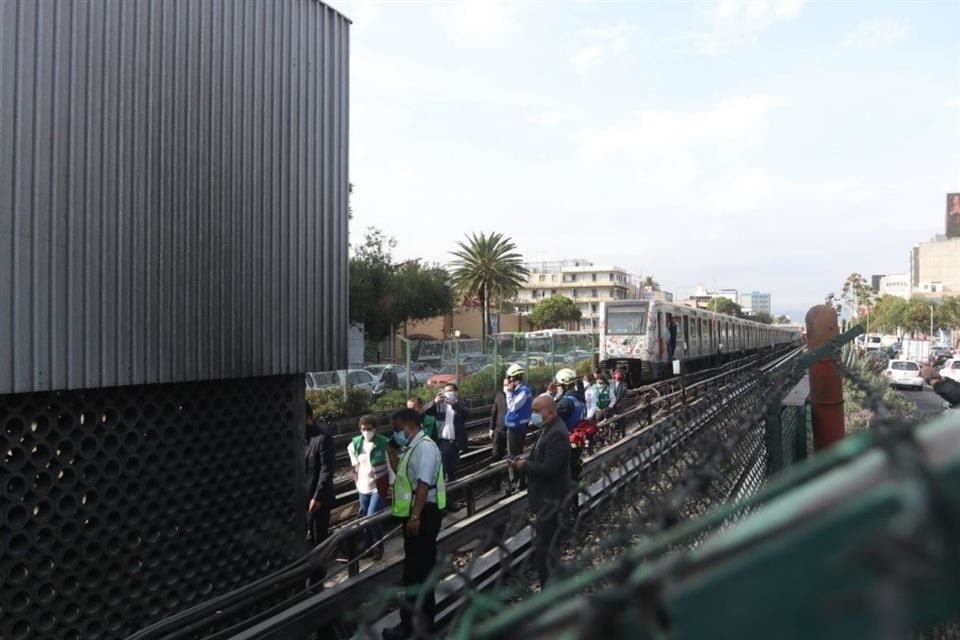 Trabajadores observan la zona siniestrada en la Línea 2 del Metro, mientras uno de los trenes permanece sobre las vías.