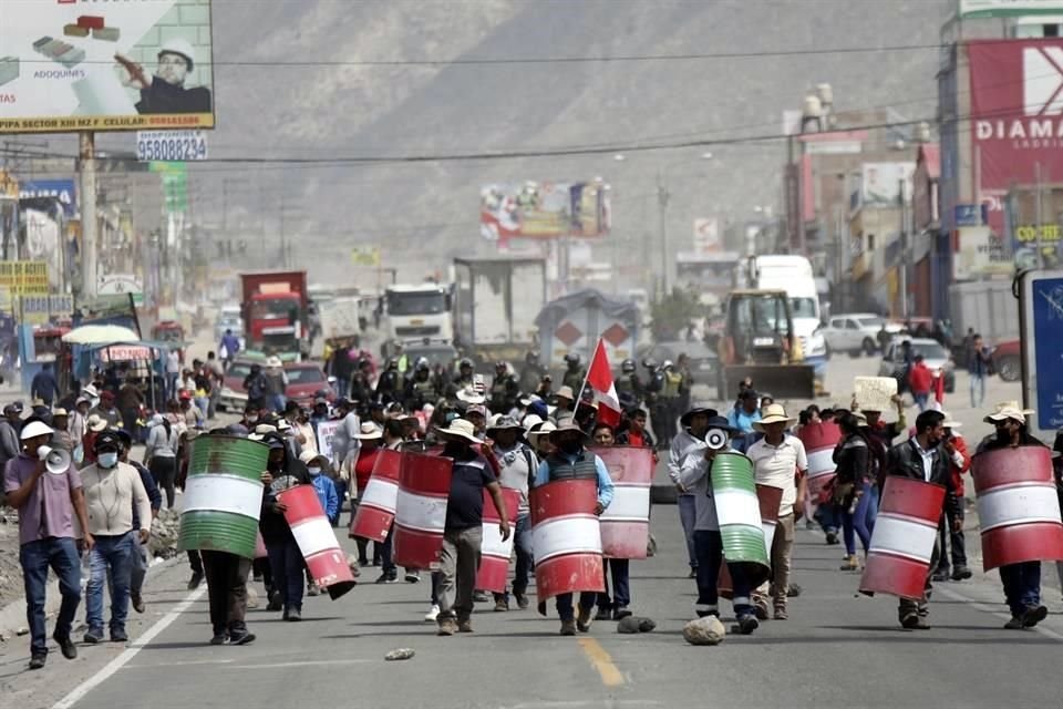 Manifestantes marchan con escudos improvisados &#8203;&#8203;durante una protesta contra el Gobierno.