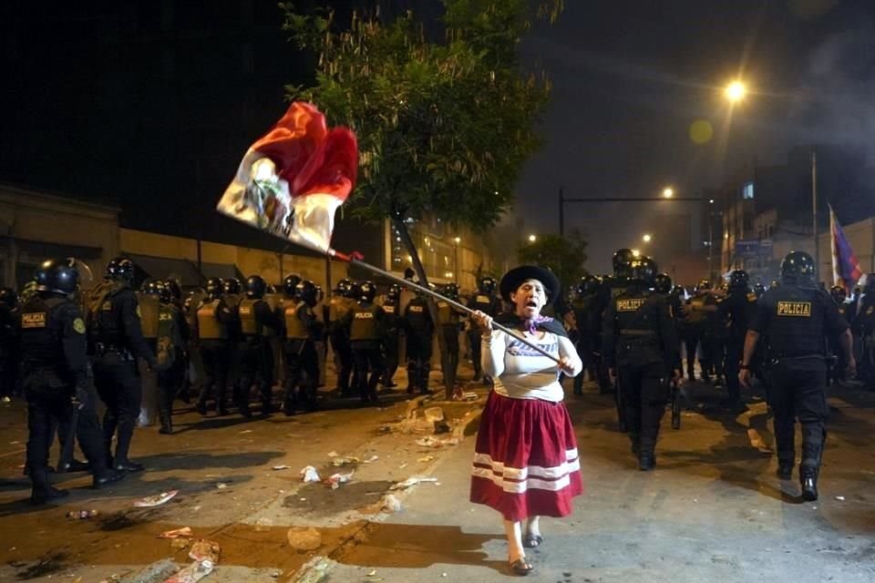 Una mujer ondea una bandera peruana durante una protesta antigubernamental en Lima.