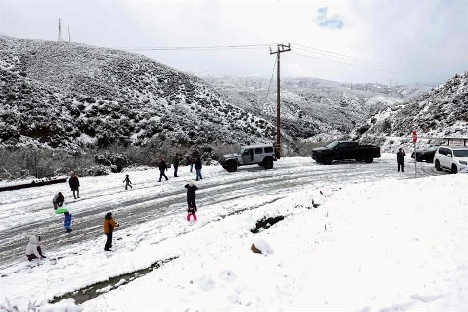 a gente aprovecha la nieve recién caída en el condado de Los Ángeles a lo largo del Cañón de San Francisquito.