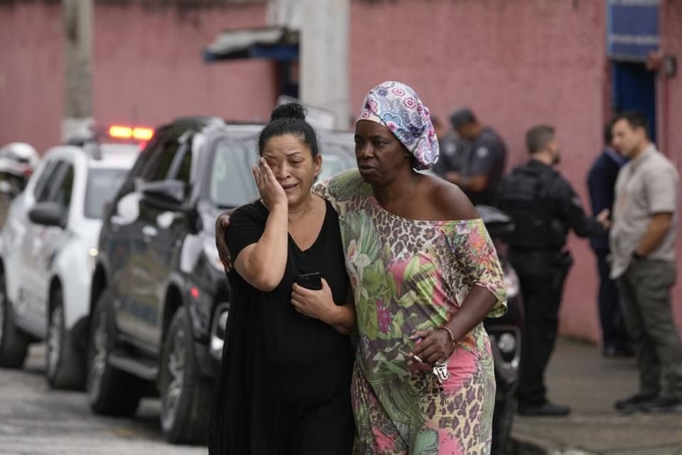 Silvia Palmieri, madre de una maestra que sobrevivió a un ataque a puñaladas en una escuela de Brasil, es consolada por una amiga el 27 de marzo.