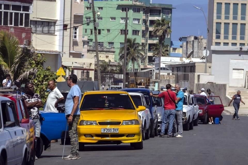 La gente hace fila para cargar combustible en una gasolinera abierta en La Habana, Cuba.