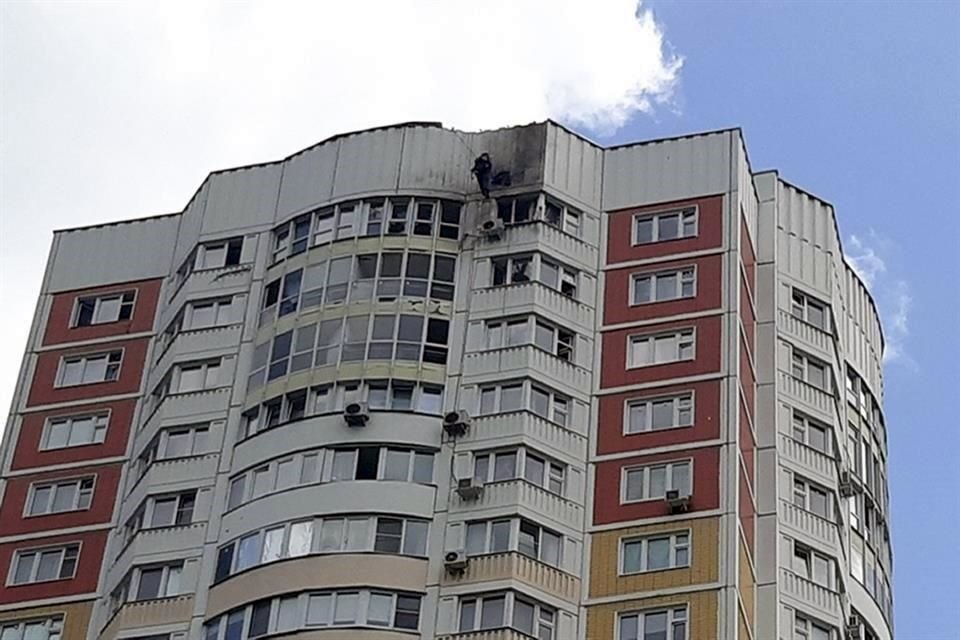 Un investigador inspecciona un daño luego de que un dron ucraniano atacara un edificio de apartamentos en Moscú, Rusia.