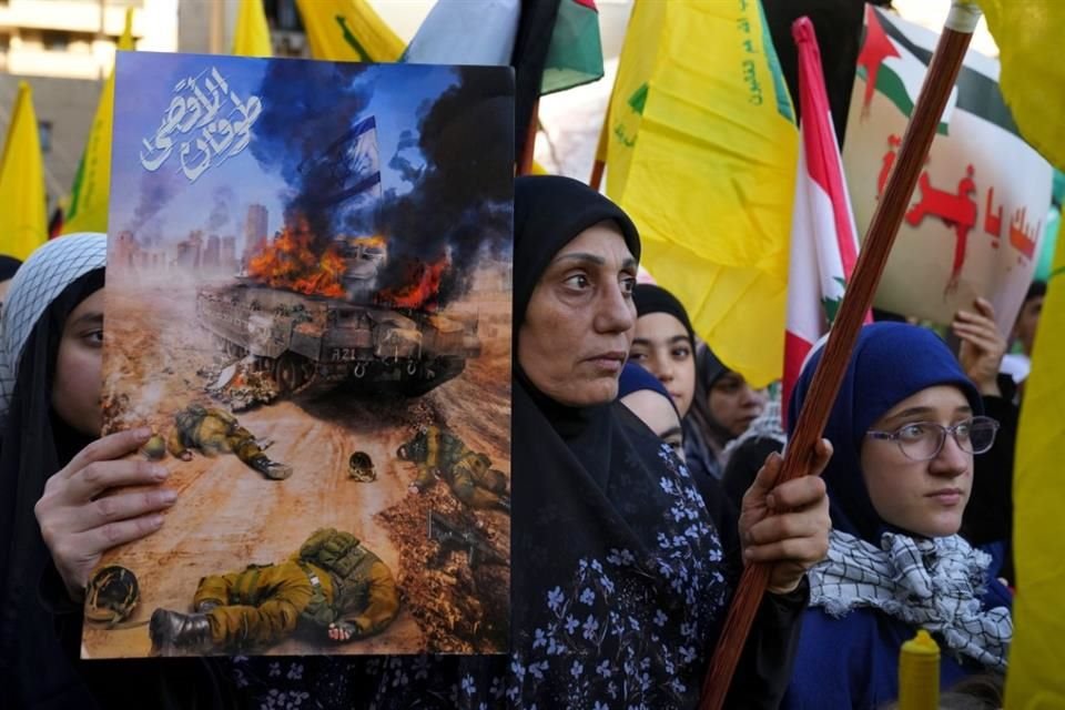 Una mujer sostiene un letrero durante una protesta en Dahiyeh, Líbano, el viernes 20 de octubre de 2023.