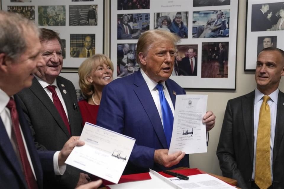 El ex Presidente Donald Trump, firma su registro para aparecer en la primaria presidencial republicana rumbo a 2024, en el congreso estatal de Nueva Hampshire, en Concord.