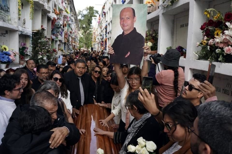 Friends and family of slain activist Adolfo Enriquez Vanderkam mourn at his funeral in Leon, Guanajuato state, Mexico, Thursday, Nov. 23, 2023. (AP Photo/Mario Armas)