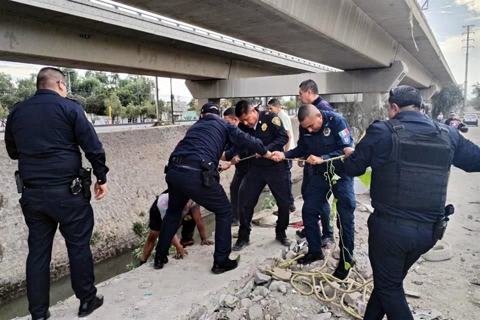 Policías ayudaron a dos hombres a salir de un río en Gustavo A. Madero.