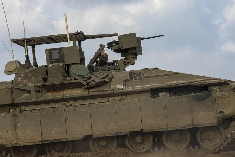 Un soldado israelí saluda mientras conduce cerca de la frontera con la Franja de Gaza.