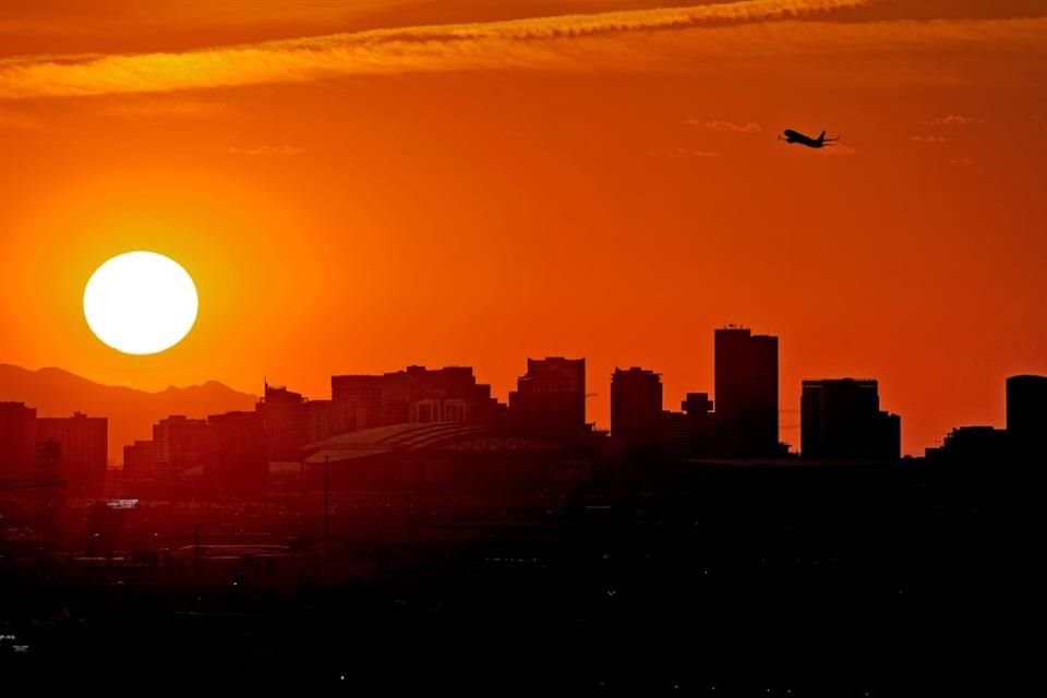Un avión despega del aeropuerto internacional Sky Harbor mientras atardece el 12 de julio de 2023, en Phoenix.