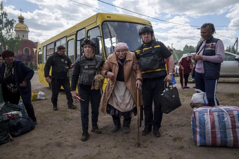 Rescatistas ayudan a evacuar a una mujer en Vovchansk, Ucrania, el 12 de mayo del 2024.