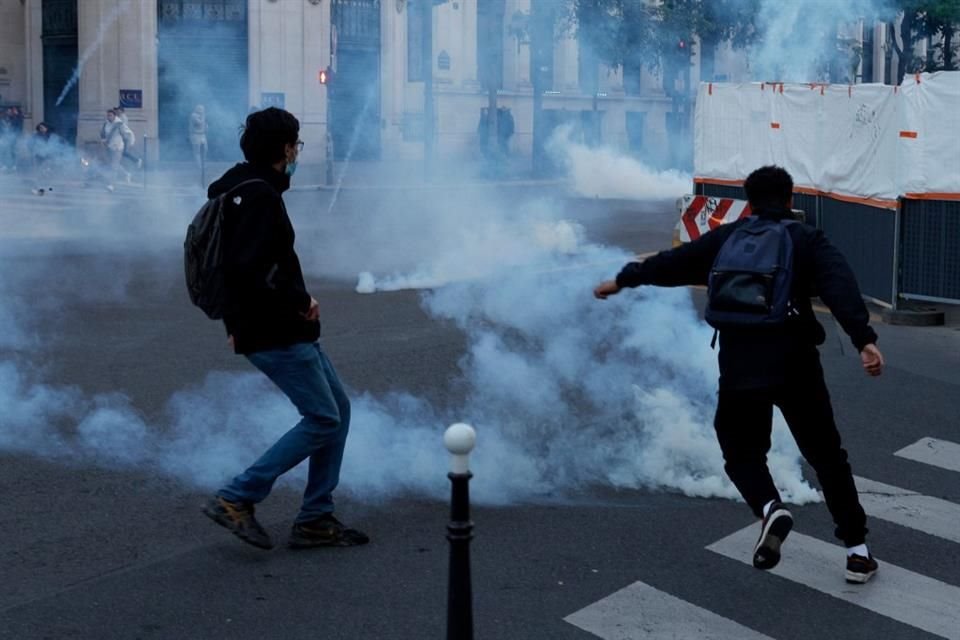 Manifestantes patean una lata de gas lacrimógeno durante una protesta contra un ataque israelí en Rafah, en París, Franica.