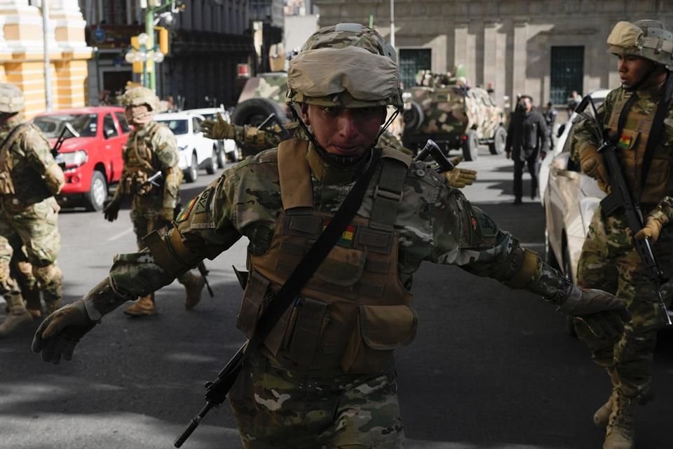 Un soldado pide a periodistas que salgan de la Plaza Murillo.