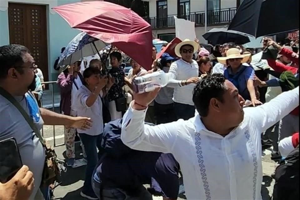 Simpatizantes morenistas y trabajadores judiciales se confrontaron al momento en que AMLO llegaba a la Casa Juárez del puerto de Veracruz. En la imagen, Jorge Cedillo lanzando una botella.