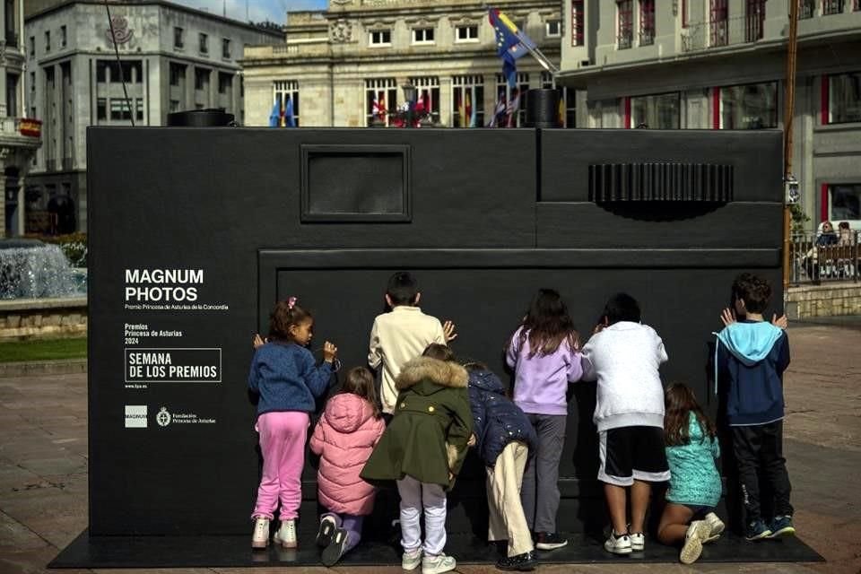 Niños juegan con una cámara de cartón gigante que evoca el Premio Asturias de la Concordia a la agencia de fotoperiodistas Magnum, previó a la ceremonia de este viernes.