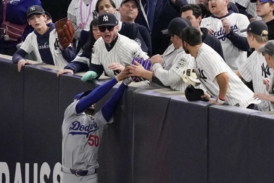 Mookie Betts atrapó la bola en terreno de foul, pero un aficionado se la quitó del guante para evitar el primer out.