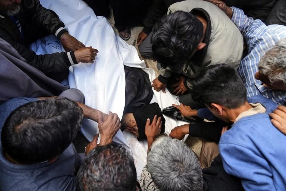 Palestinos lloran sobre el cuerpo de Al-Akhras, que murió cuando se dirigía a un centro de ayuda en Gaza.