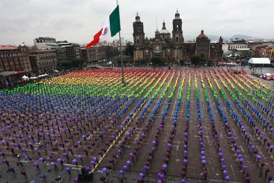 Cientos de personas se reunieron en la Plancha del Zócalo, con sombrillas de colores, para formar la bandera LGBT+ más grande del mundo.