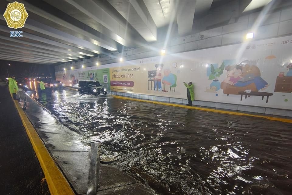 Policías realizan labores en el bajopuente de la Carretera Picacho Ajusco y el Periférico, debido a los encharcamientos en la zona.