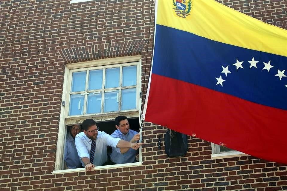 Carlos Vecchio (derecha) agitó la bandera venezolana desde la Embajada en Washington.