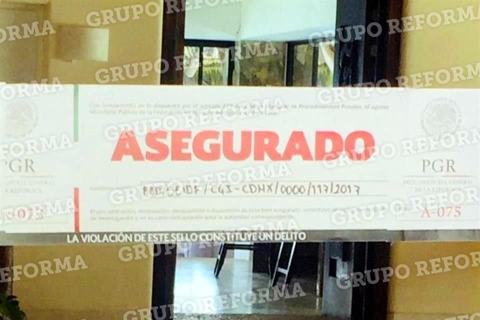 Agentes del Ministerio Público Federal y de la Policía Federal Ministerial pegaron los sellos de aseguramiento en la casa del condominio Quinta Mar de Ixtapa.