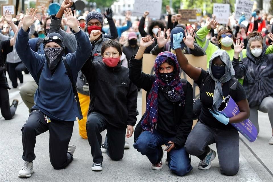 Manifestantes en Seattle se arrodillan durante una protesta.