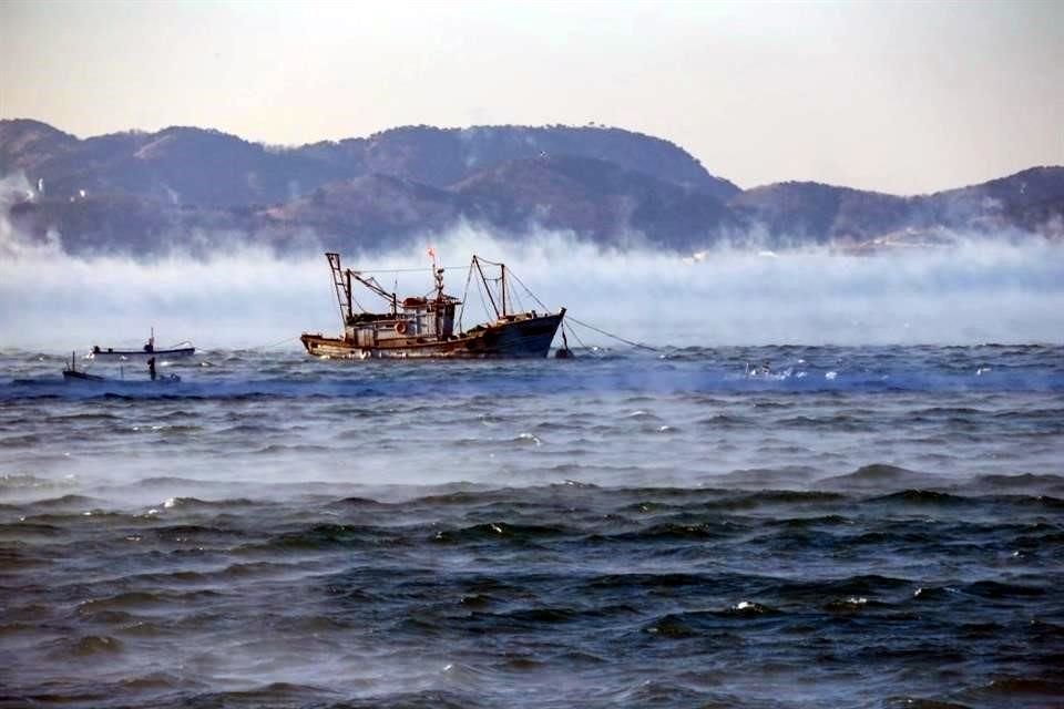 Un barco pesquero en el Ártico se encuentra en medio del humo que resulta de aire helado que pasa sobre agua caliente.