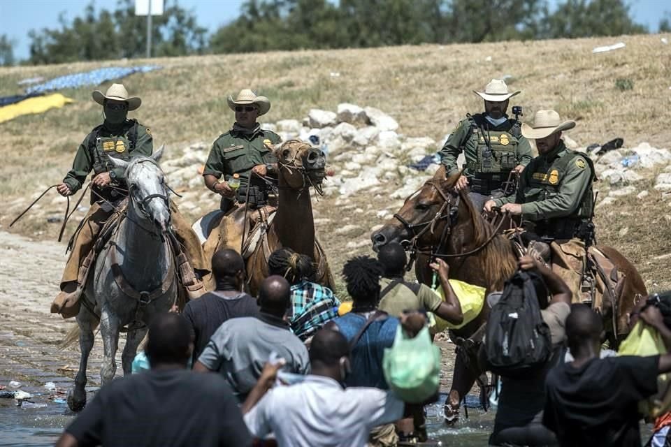 Agentes fronterizos a caballo impiden el paso a migrantes haitianos en Del Río, Texas.