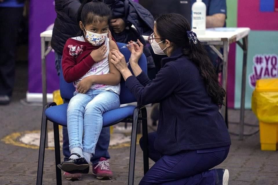 Una trabajadora de salud aplica la vacuna contra Covid-19 a una niña en la escuela Providencia, de Santiago, Chile.
