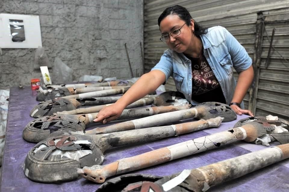 Mara Abigaíl Becerra, arqueóloga responsable del salvamento, muestra algunos elementos de la ofrenda.
