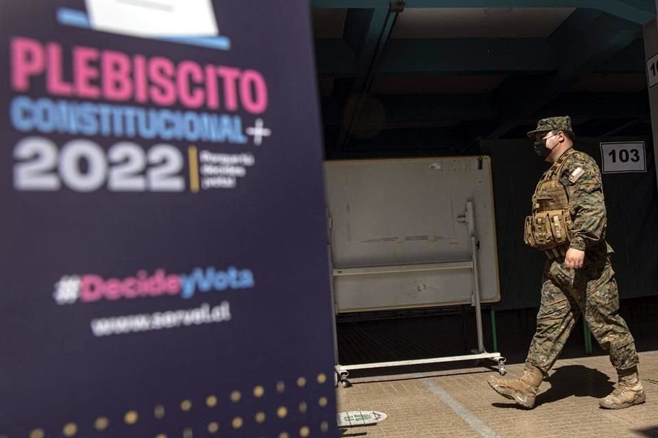 Un soldado pasa por una de las casillas en las que los chilenos votarán si aceptan o no la nueva Constitución.