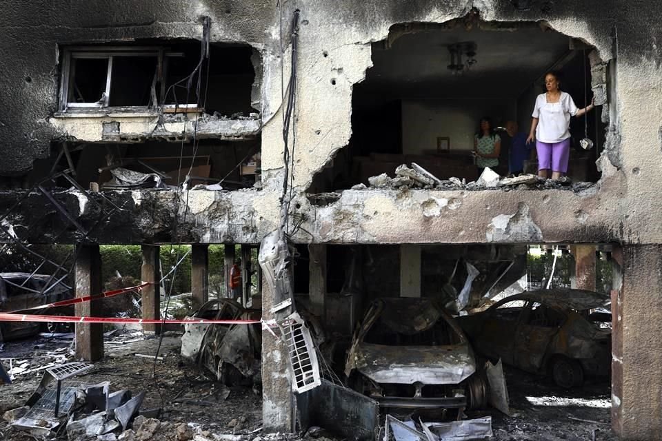 Una mujer revisa los daños hechos a su hogar en Israel, por un cohete lanzado desde Gaza.